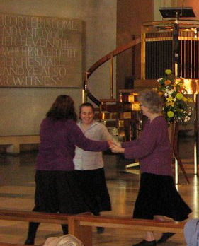 Trio in circle, in front of a pulpit