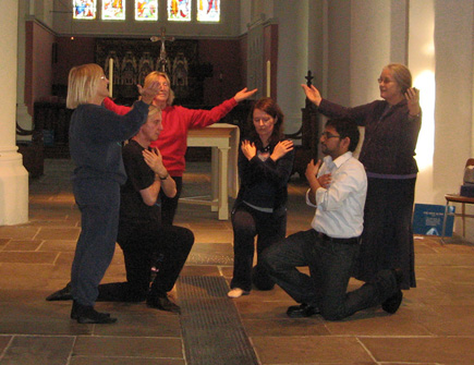 dancers in semi-circle, some kneeling