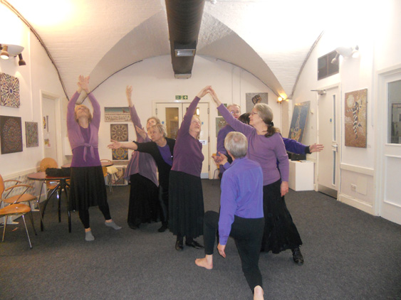 Dancers reach upwards or outwards to the words 'True believer' 